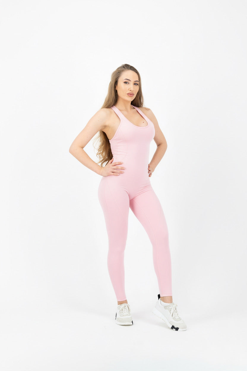 Woman wearing a pink jumpsuit on a white background