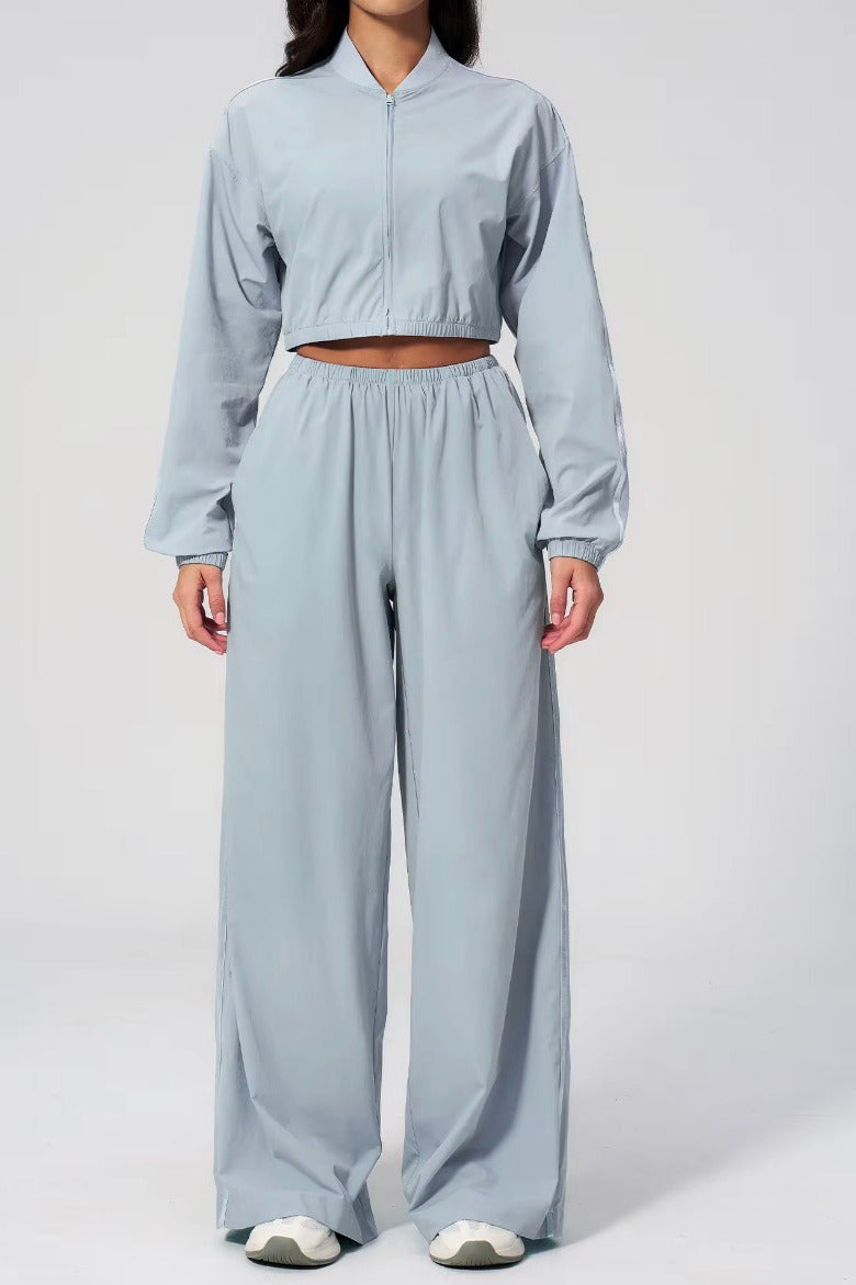 Person wearing a light blue outfit with wide-leg pants on a white background